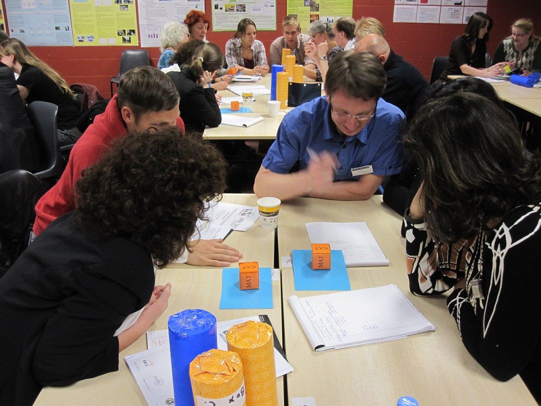 Student teams at tables